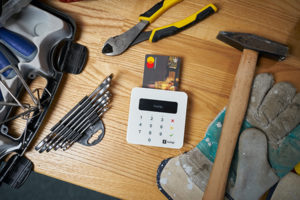 Manasquan HVAC repair tools including a mobile payment unit with credit card inserted 